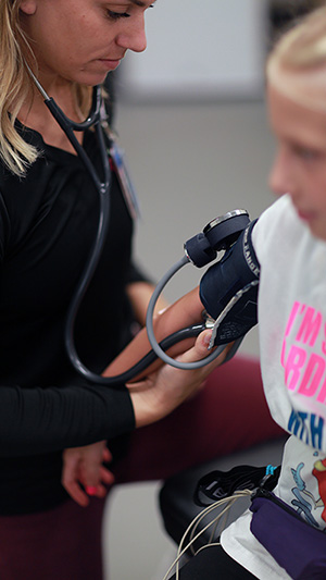 A photo of a patient having her blood pressure read.