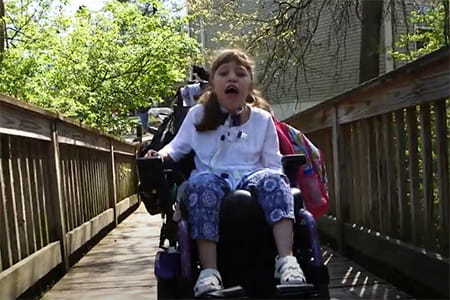 A photo of Jerrica going for a stroll in her wheelchair.