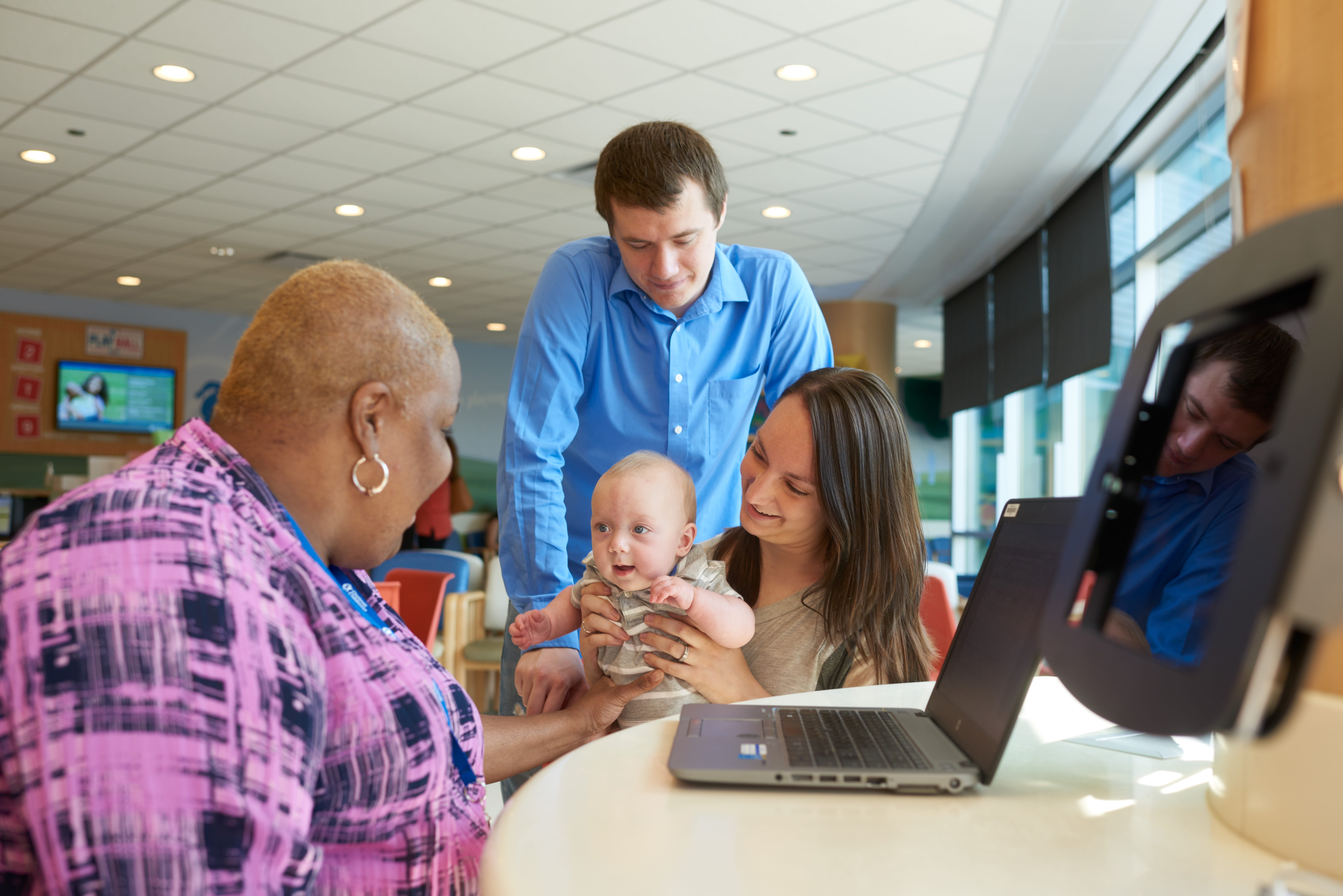 A patient and family talking with a staff member.