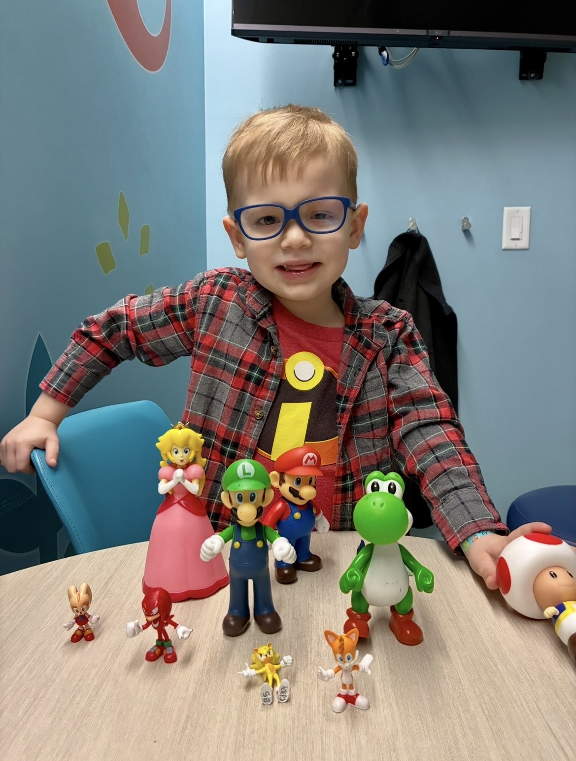 Owen playing with Child Life toys during appointment.