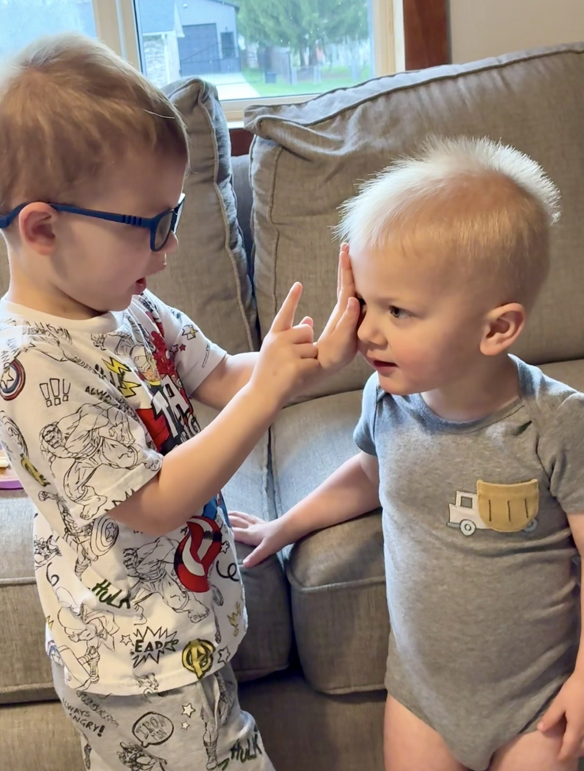 Owen giving his brother an eye exam at home