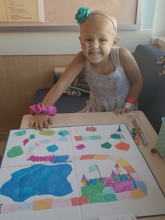 Josie and her homemade board game.