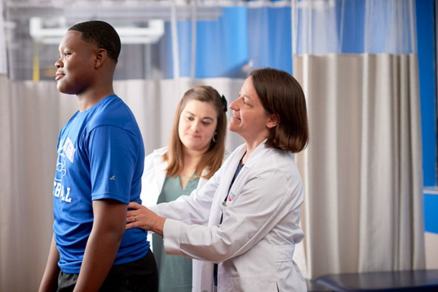 An image of a sports medicine doctor talking to a patient.
