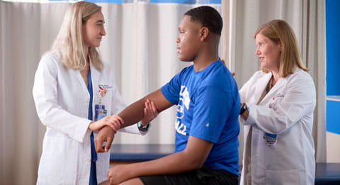 Doctor and fellow exam a patient.