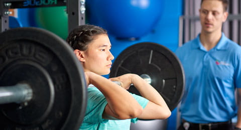 Female athlete lifting weights.