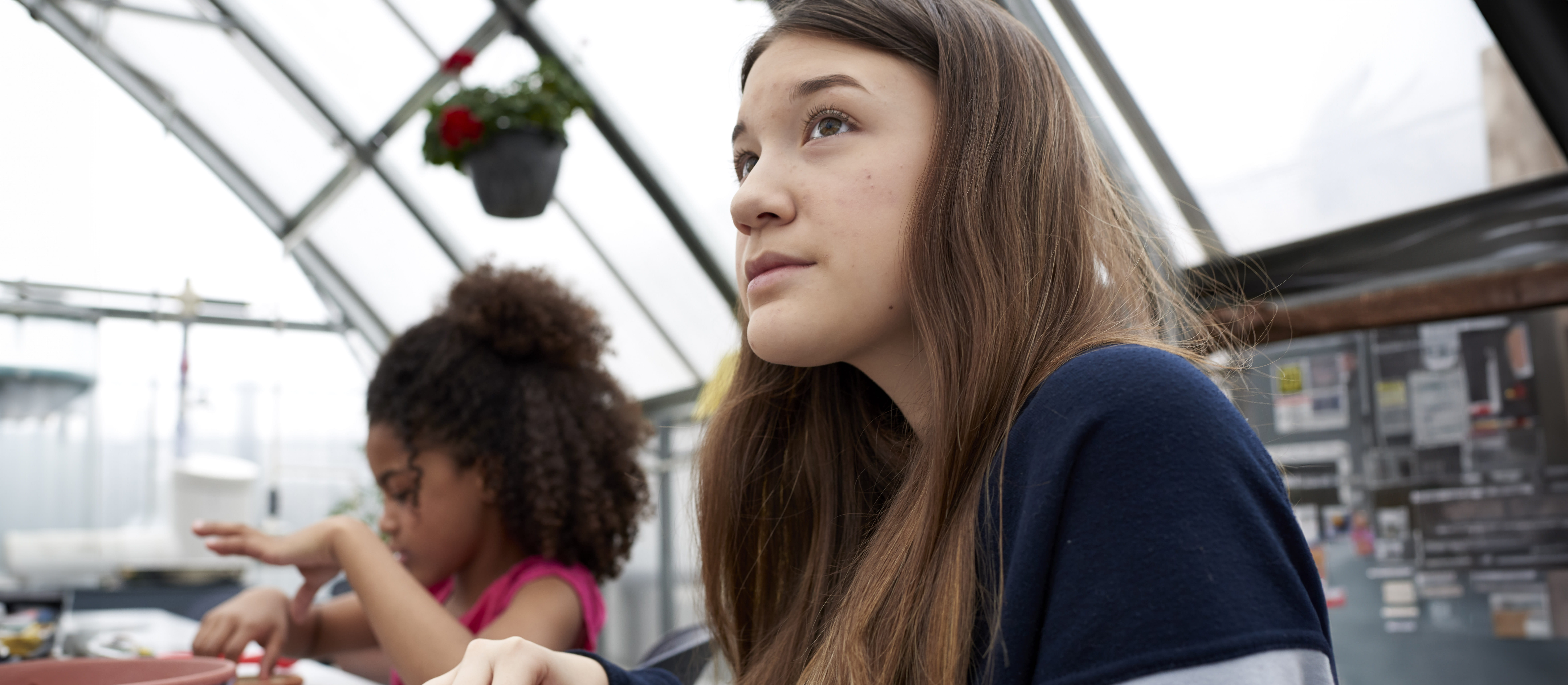 Teen girl looking off into the distance.