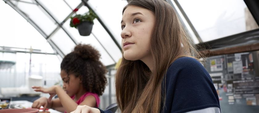 Teen girl looking off into the distance.