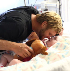 Dad kisses his child.