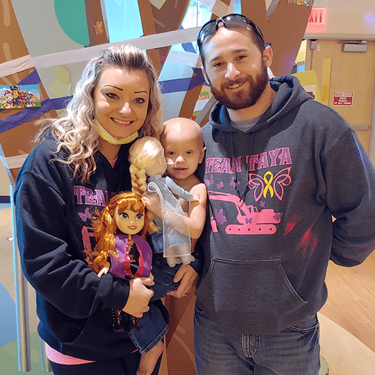Taya and her parents after completing proton therapy.