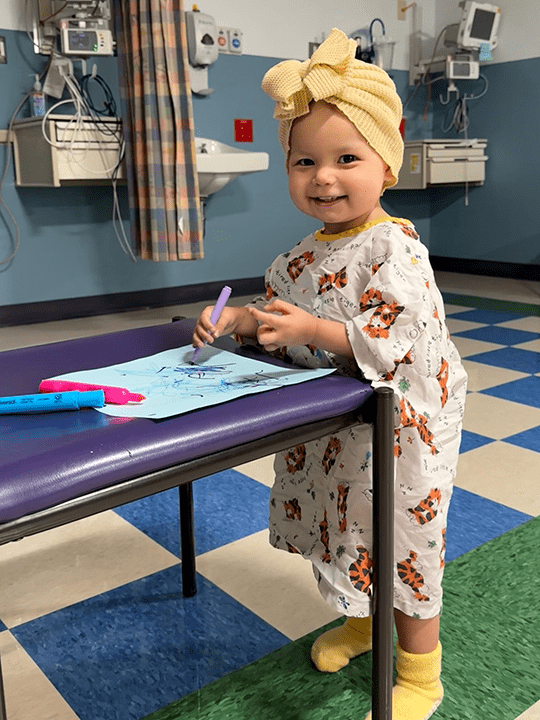 Raegan draws a picture.