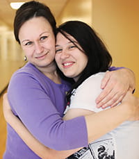 Parent and child hug each other.