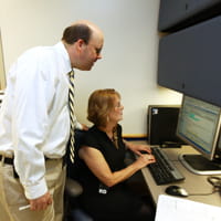 A doctor taks to a staff member at the Surgical Weight Loss Program for Teens.