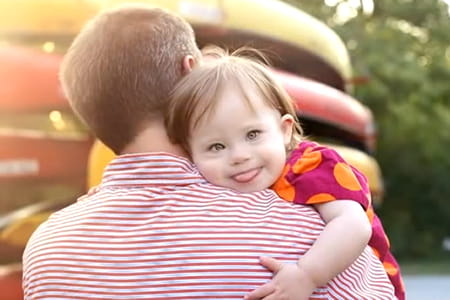 Down syndrome patient hugging her dad.