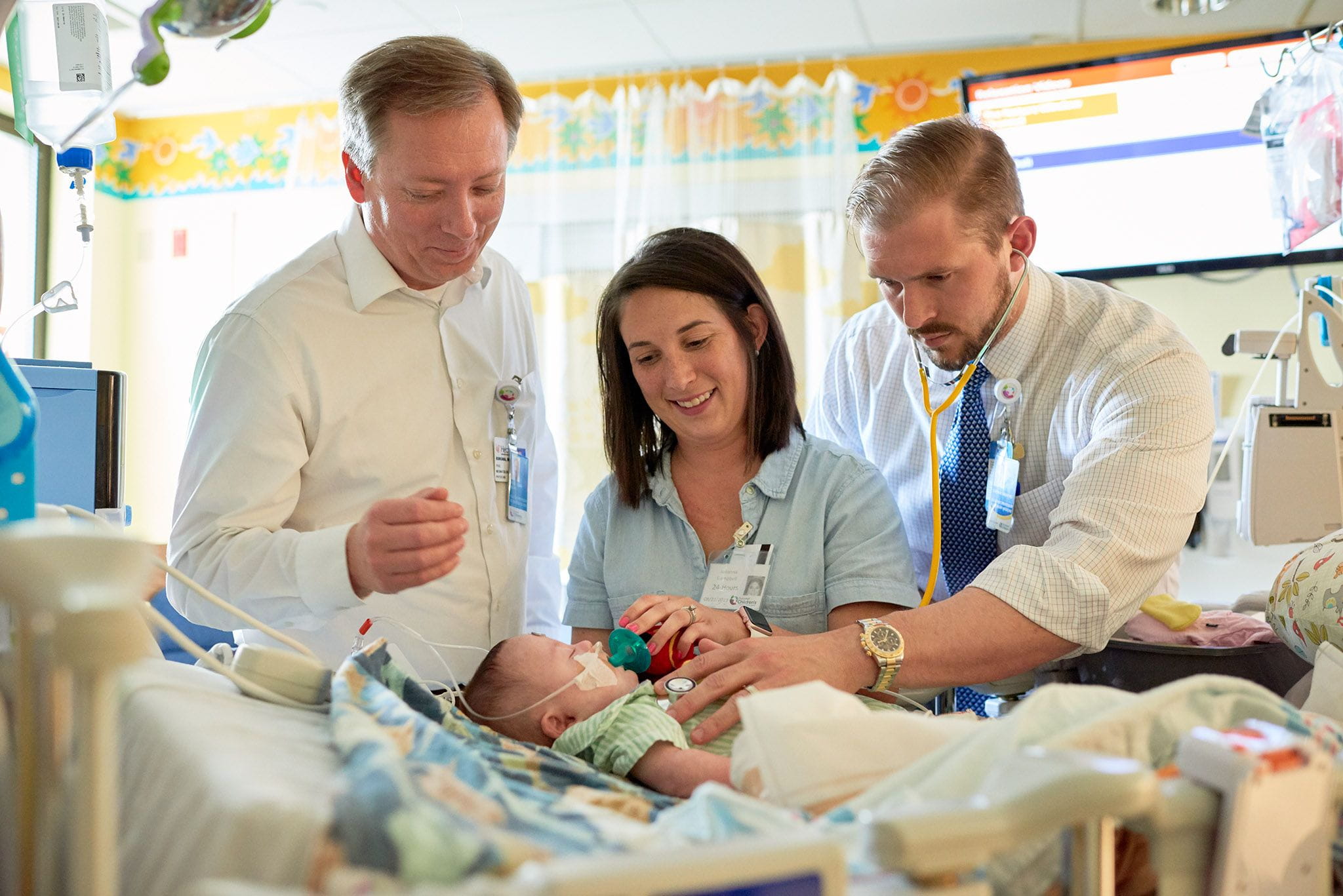 A photo of a provider, patient and family.
