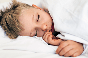 A photo of a boy sleeping.