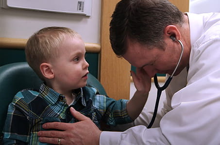 A photo of Grayson with a doctor.