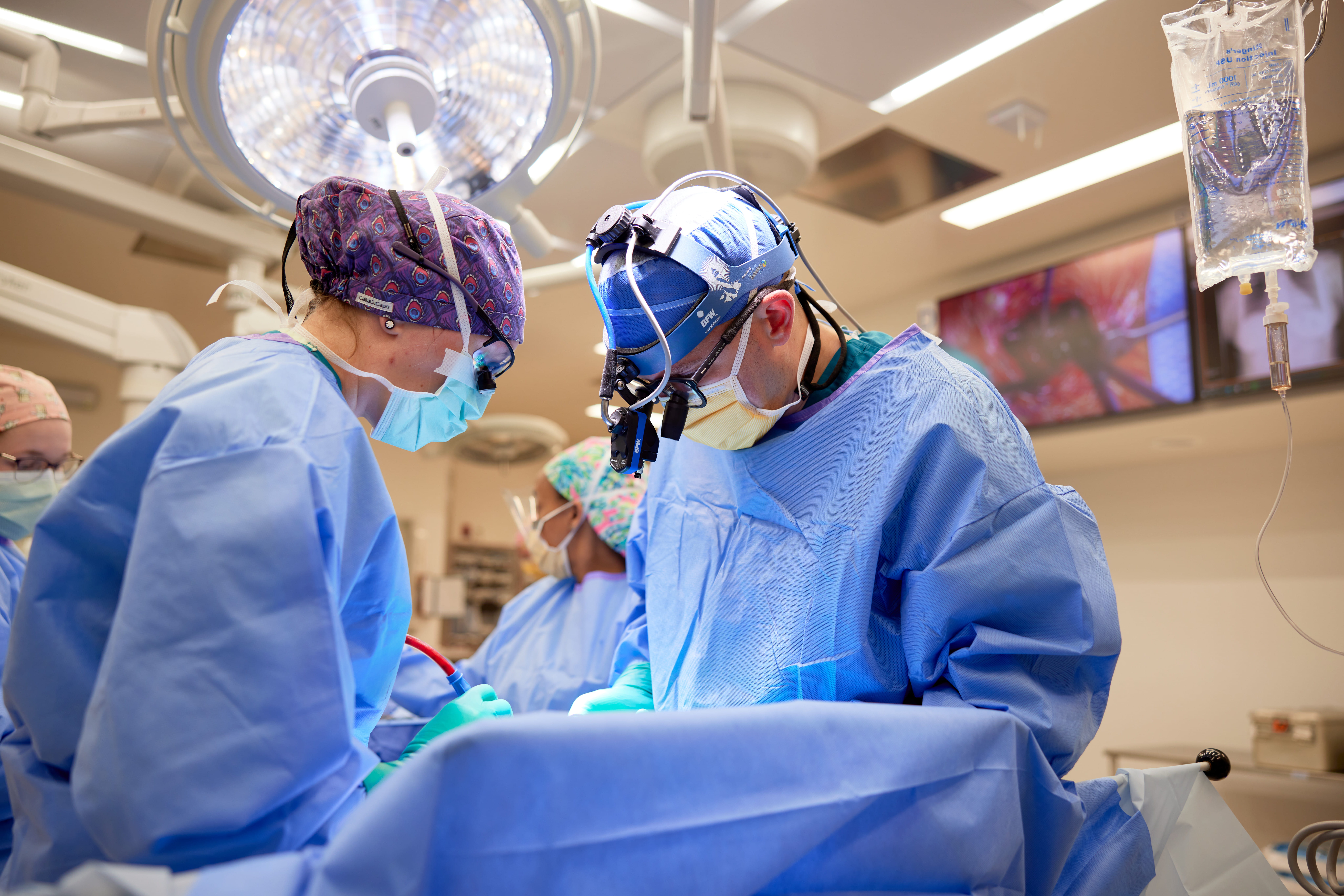 Clinicians perform heart surgery.